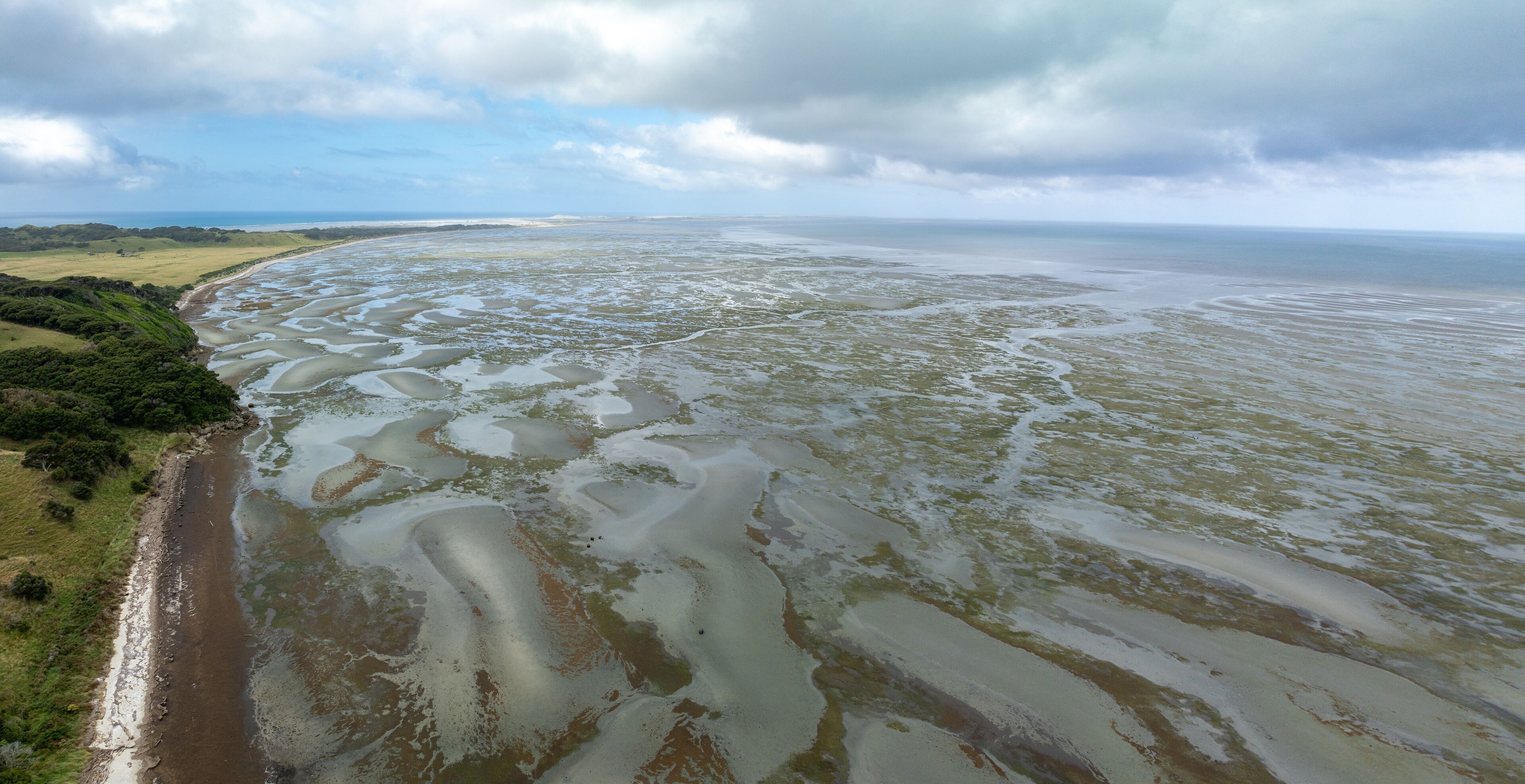 The Farewell Spit at the top of the South Island at low tide at sunset. Puponga, Collingwood, Tasman, New Zealand.