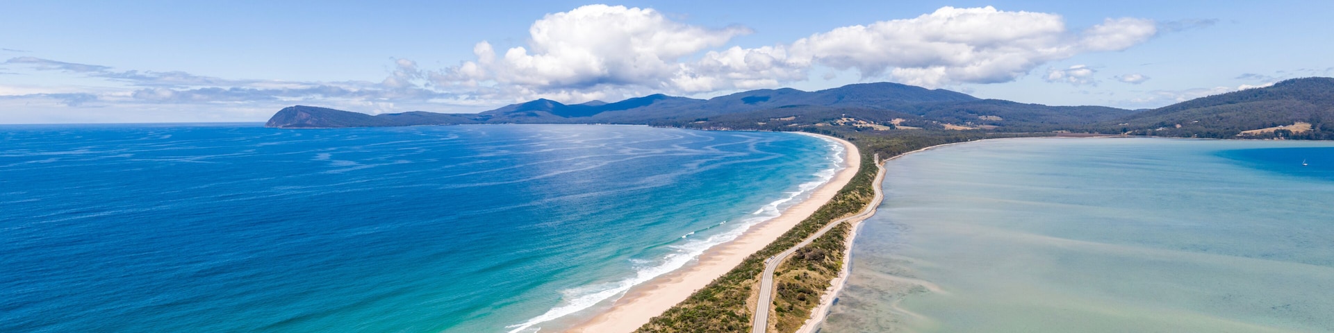 High angle aerial drone view of the Neck, an isthmus of land connecting north and south Bruny Island in southern Tasmania, Australia that offers 360 degree views and is a famous tourist destination.