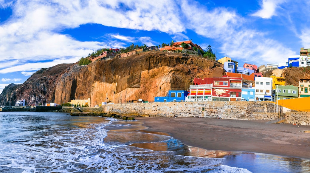 Spain Gran Canaria Puerto de Sardina high resolution 11K panorama of coastal village. Colorful houses on volcanic black sand beach with ochre cliffs. Scenic Canary Islands travel wall art