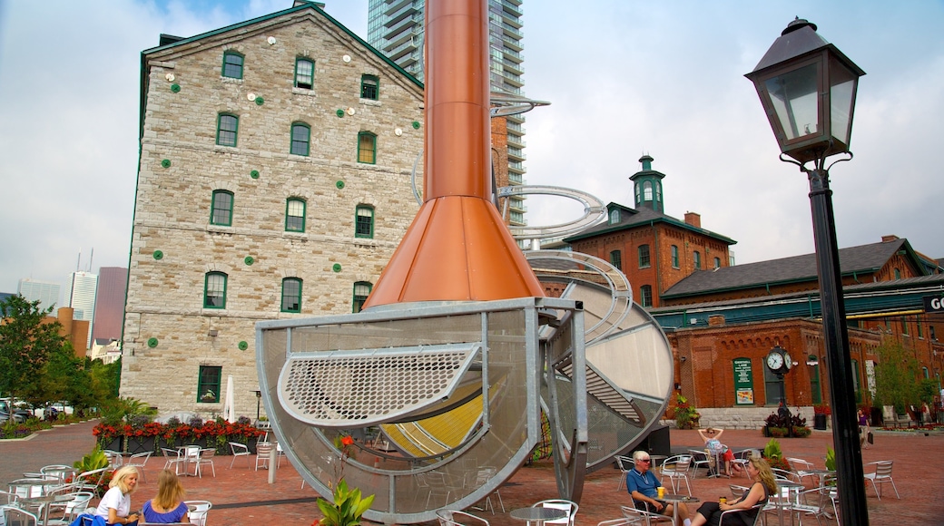 The Distillery Historic District which includes outdoor eating, a city and outdoor art