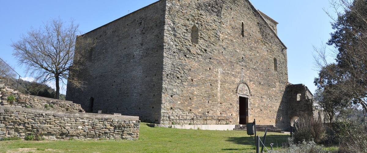 A large stone building with a flat roof and a small arched entrance.