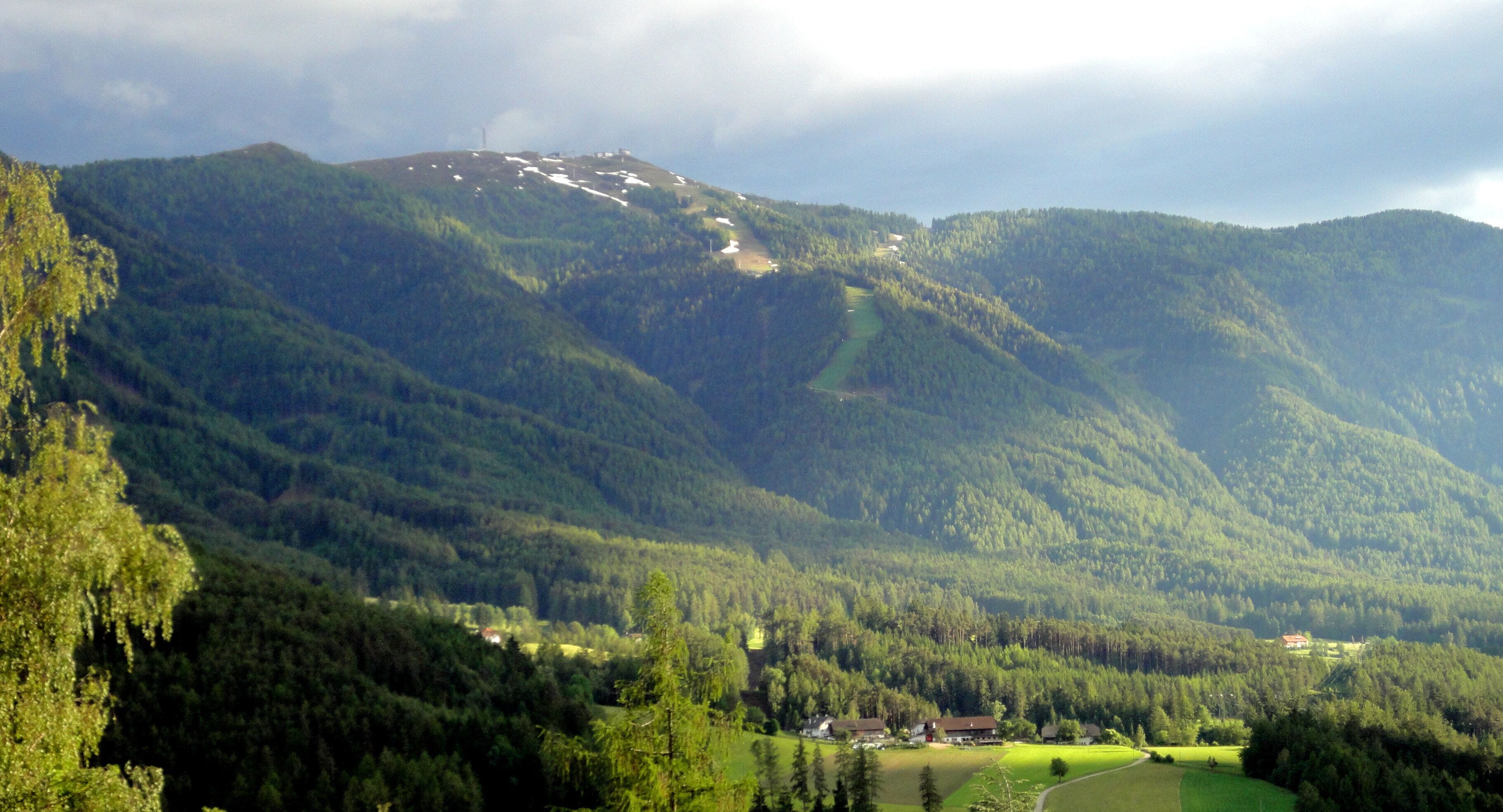 A mountainous landscape with a village nestled in the valley.