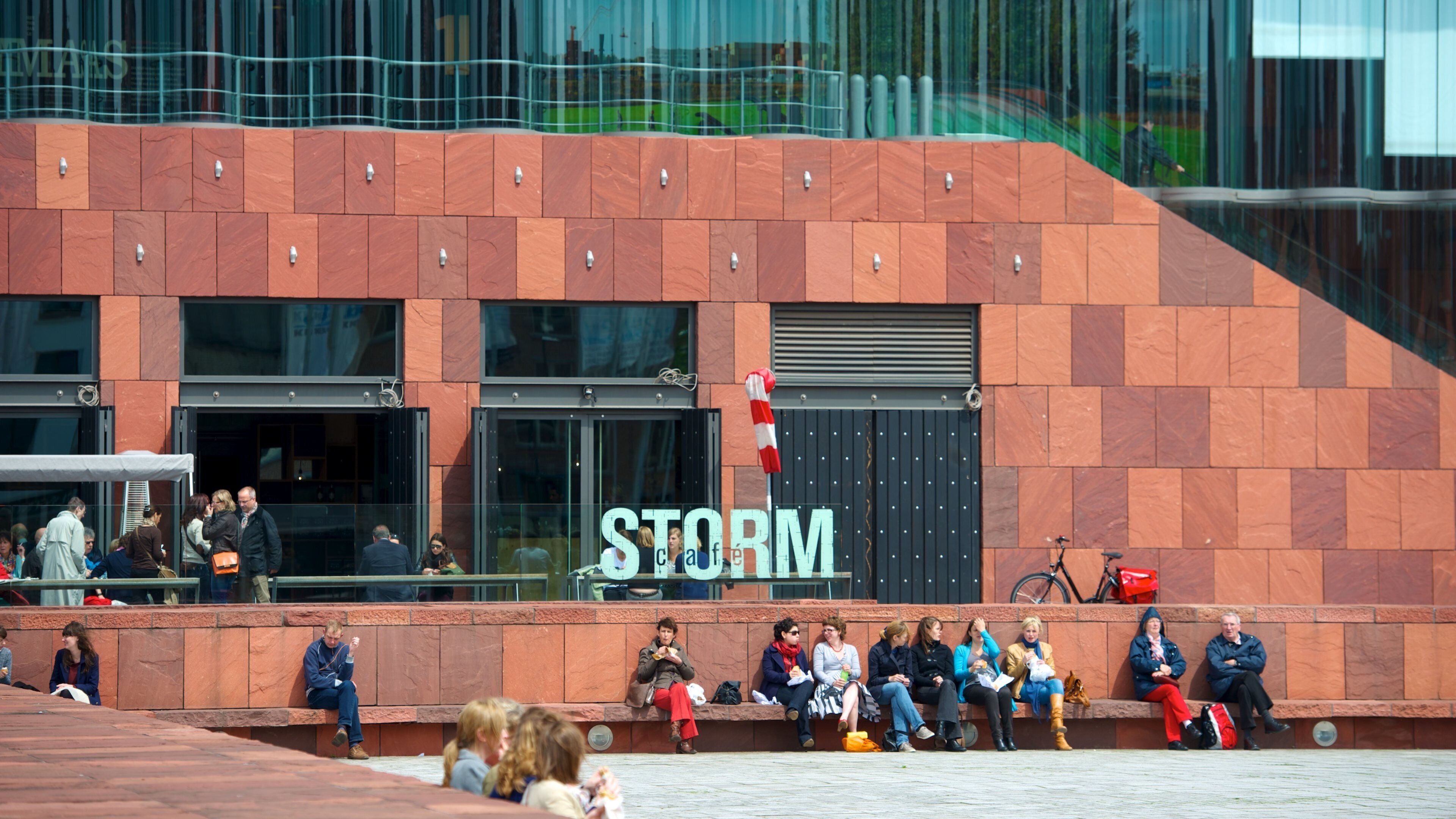Museum Aan de Stroom featuring signage as well as a large group of people