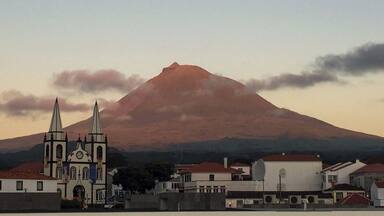 If you are traveling to the Açores (Azores), I highly recommend a stop on Pico Island. The unique landscape of volcanic rock, historical vineyards, and Mount Pico jutting out of the center of the island are breathtaking. You can stay on the island, or if you prefer, you can stay in Horta on Faial Island and take the ferry across for the day. Here, we captured the pinks of the sunset reflecting on Mount Pico as we pulled out of the ferry station in Madalena, headed back to Horta. #InStone #VolcanicRock #MountPico #Azores
