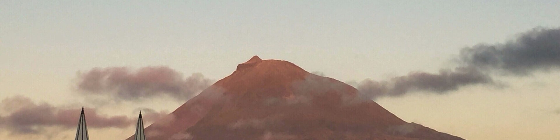 If you are traveling to the Açores (Azores), I highly recommend a stop on Pico Island. The unique landscape of volcanic rock, historical vineyards, and Mount Pico jutting out of the center of the island are breathtaking. You can stay on the island, or if you prefer, you can stay in Horta on Faial Island and take the ferry across for the day. Here, we captured the pinks of the sunset reflecting on Mount Pico as we pulled out of the ferry station in Madalena, headed back to Horta. #InStone #VolcanicRock #MountPico #Azores
