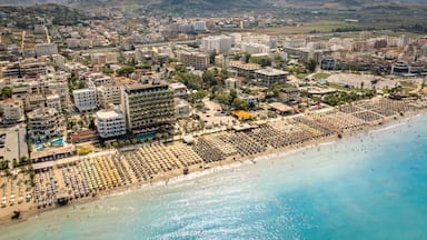 Golem, Durres, Albania - 22 august 2023: Aerial view to sandy beach full of umbrellas and people in summer season 2023