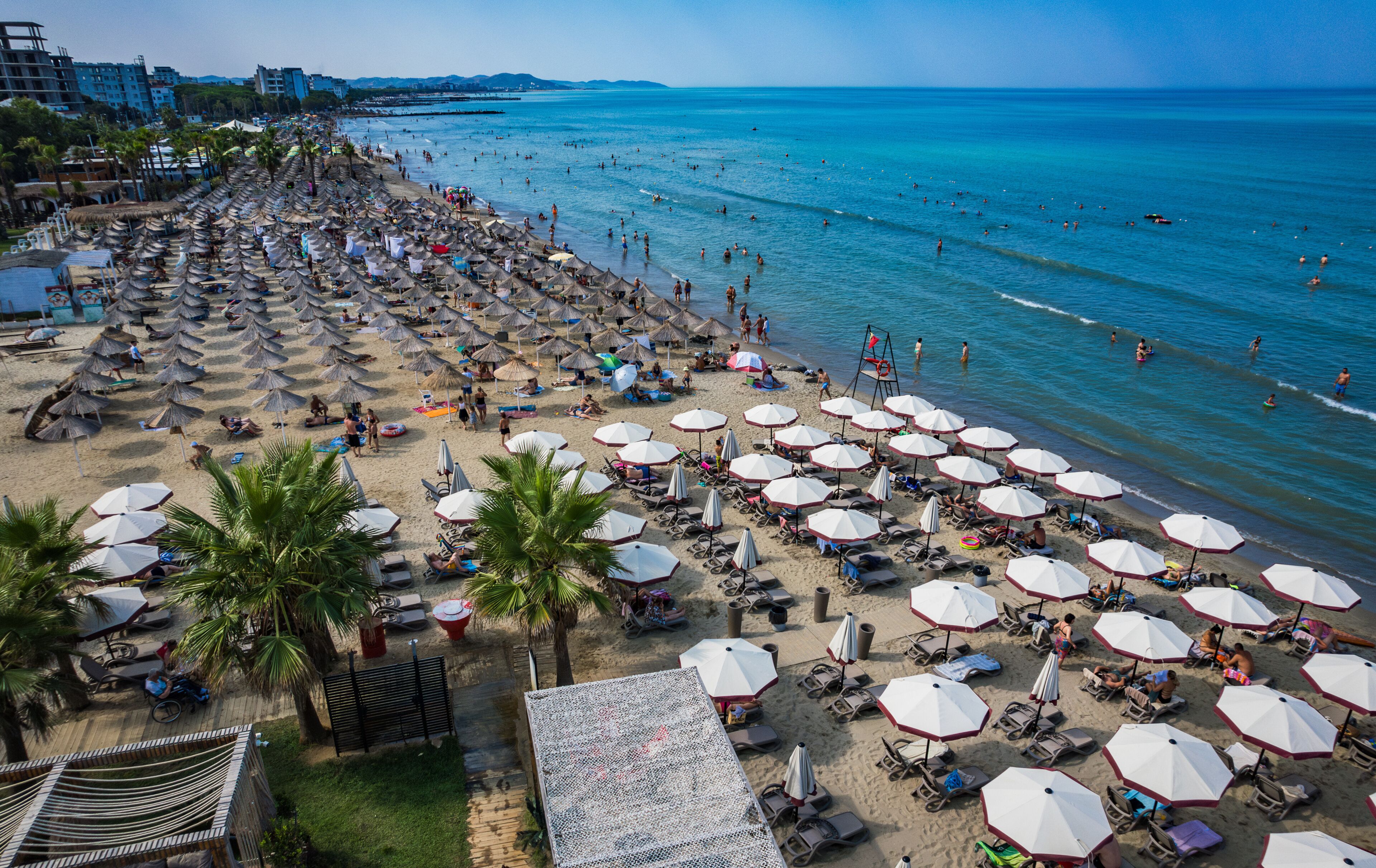  Golem, Durres, Albania - 22 august 2023: Aerial view to sandy beach full of umbrellas and people in summer season 2023