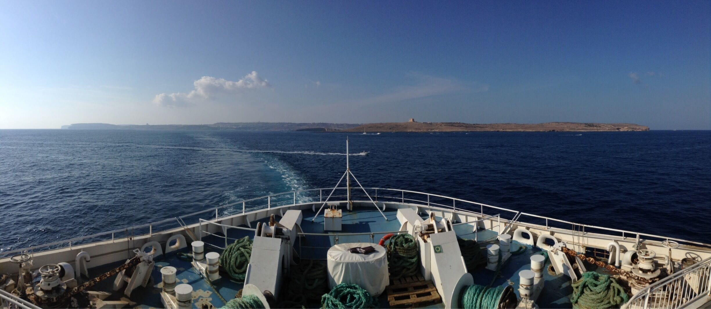 Ferry between Malta and Gozo. The closer island is Comino (where you can find the blue lagoon) and the island behind is Gozo.

Ferry is €4.65 return, payable upon departing Gozo. 