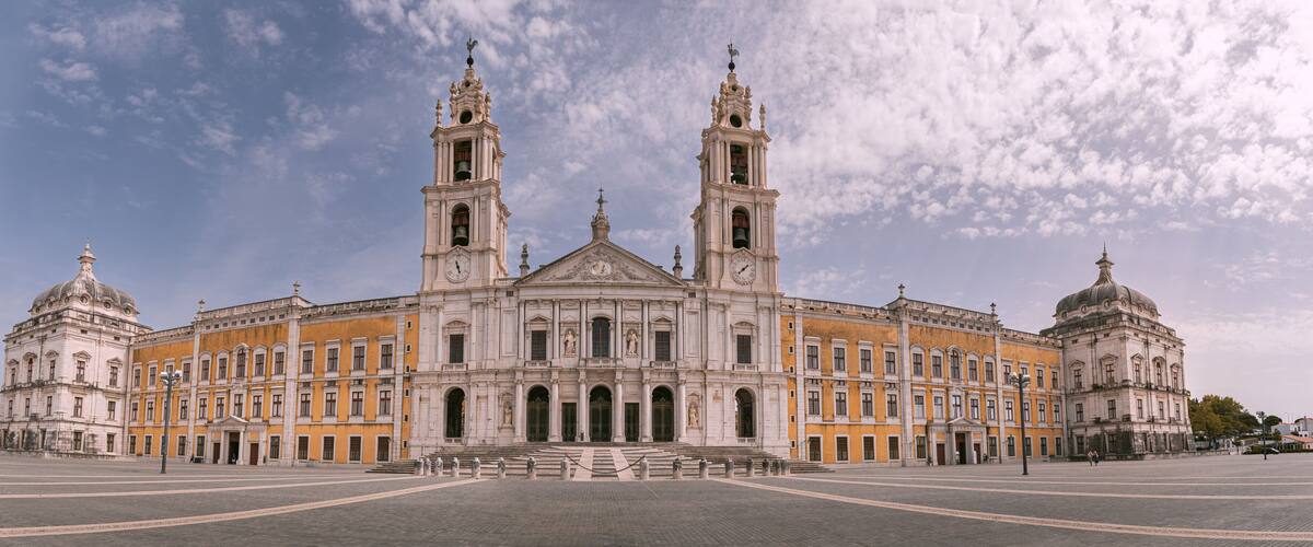 A large historic building with two towers and a central dome.
