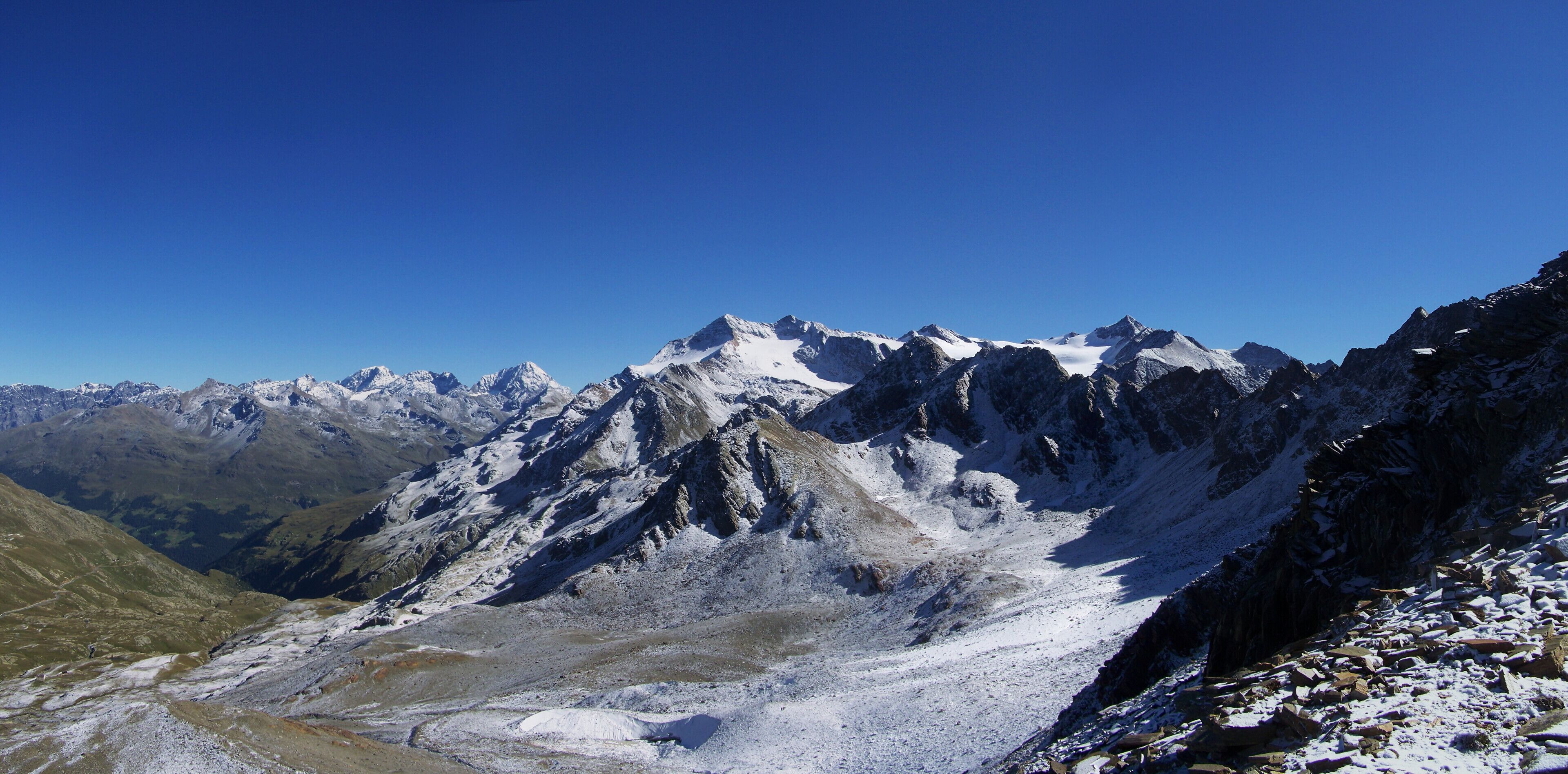 A snow-covered mountain range with clear blue skies.