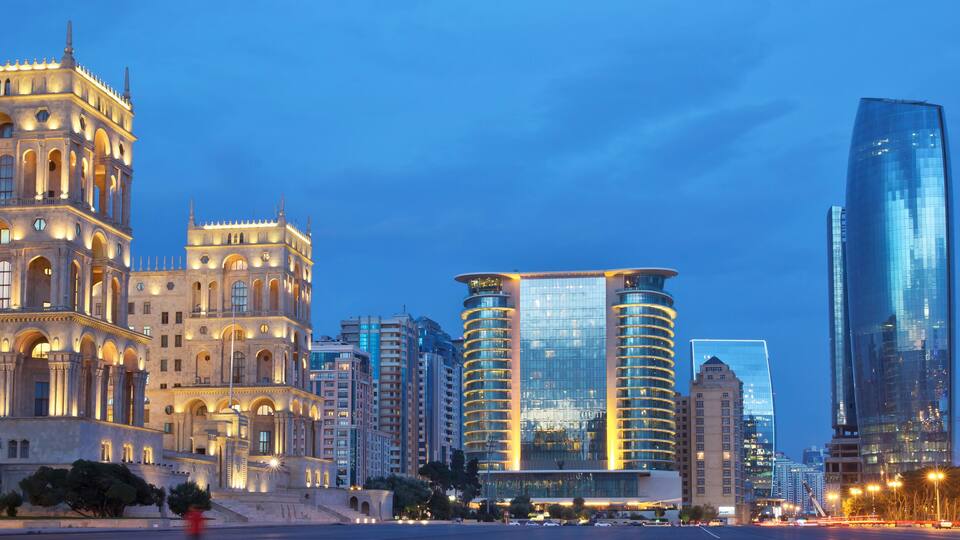 A cityscape with historic architecture and modern skyscrapers.