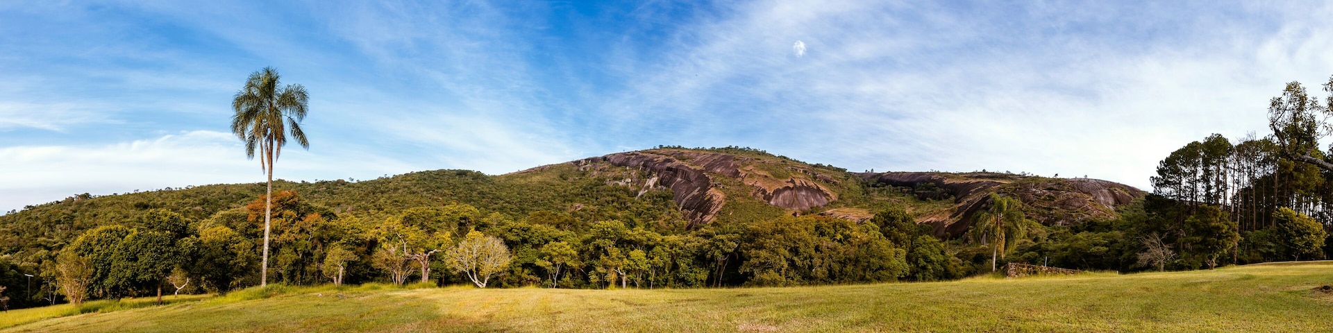 180º panoramic view of the natural monument of Pedra Grande in Atibaia, São Paulo - Brazil. Local vegetation, mountain and blue sky with clouds.
