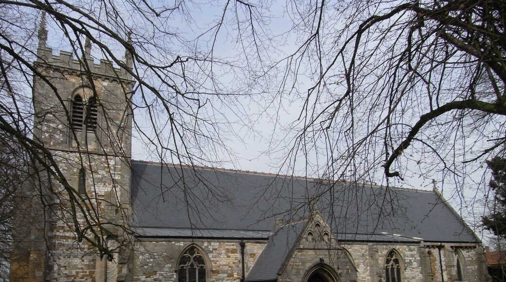 This is Grade 1 listed building. "Parish church. Late C12 - early C13 chancel, C13 tower, nave arcades and south door, C14 aisles, C15 tower parapet. Restorations of 1884 by J Fowler of Louth included rebuilding south porch, new nave and chancel roofs. Limestone, ironstone and chalk rubble and squared blocks with ashlar dressings; ashlar south porch. Lead roofs to aisles, slate roofs to remainder. West tower, 4-bay aisled nave with south porch and 3-bay chancel. 2-stage tower: moulded plinth, angle buttresses to first stage, quoins to second stage. Tall 1st stage has west lancet, cill string course, small lancet to south and clockface to west, moulded string course. 2nd stage has tall twin belfry openings with polygonal shafts in pointed chamfered reveal with shaft-rings. Corbel table, embattled parapet with C19 restored crocketed pinnacles.." www.britishlistedbuildings.co.uk/en-165883-church-of-sain... The church, which is difficult to photograph due to surrounding trees, contains a notable black Tournai marble font www.flickr.com/photos/dhwright/291713212/