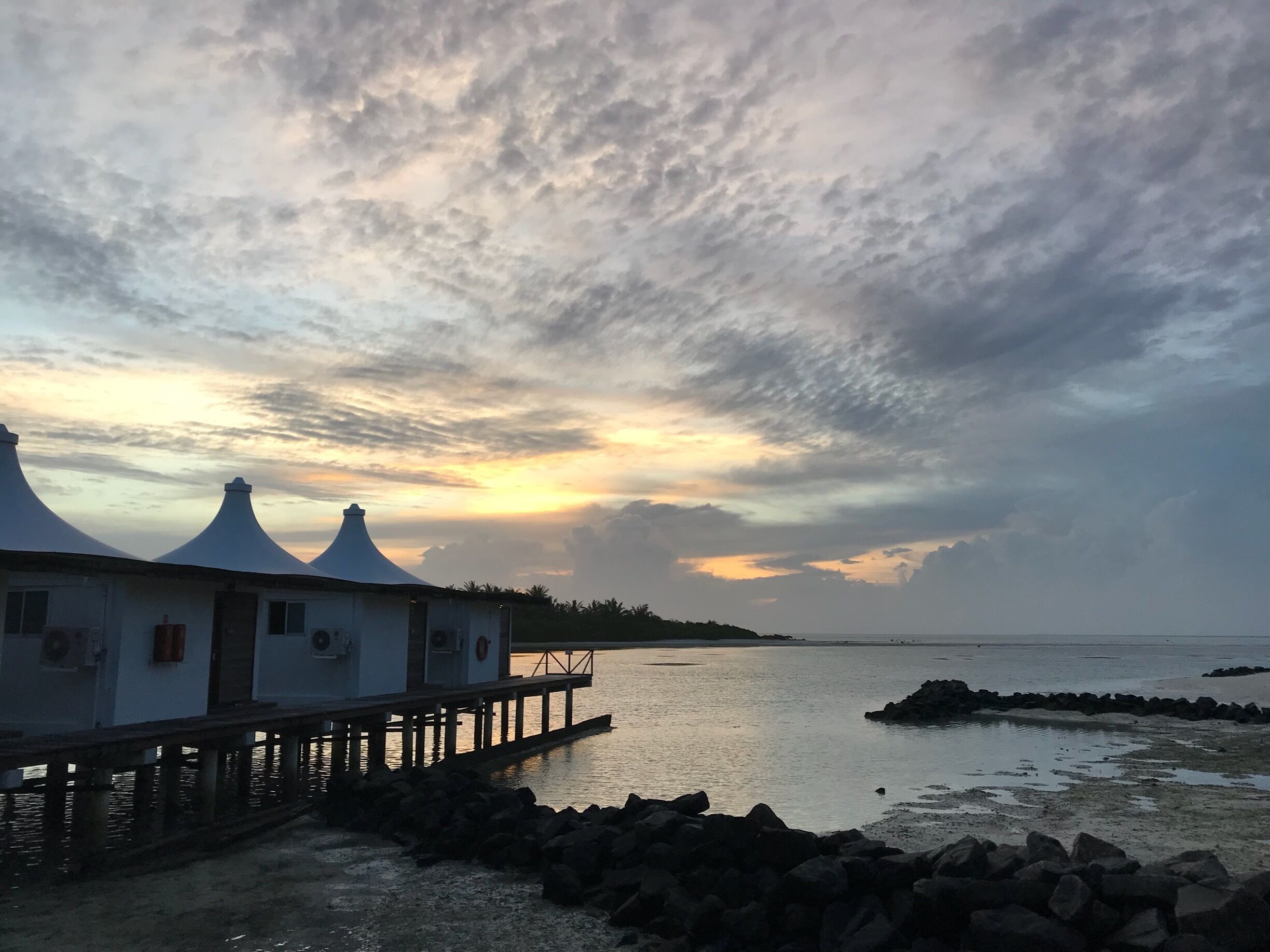 The sun setting behind water bungalows. The place is amazing,Maldives really is paradise. 🇲🇻