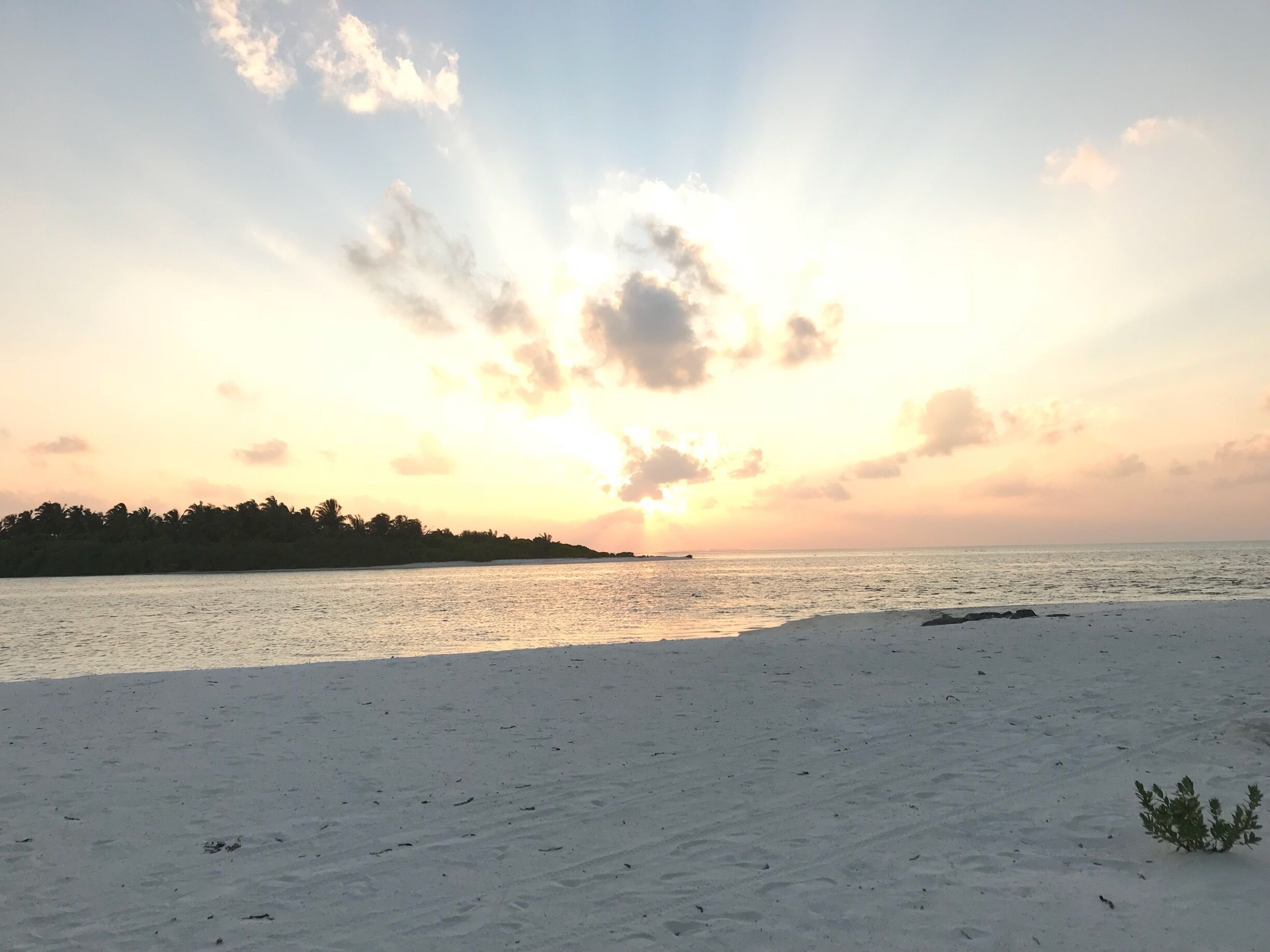 Sun setting on the horizon. Beautiful sea and beach as well. 