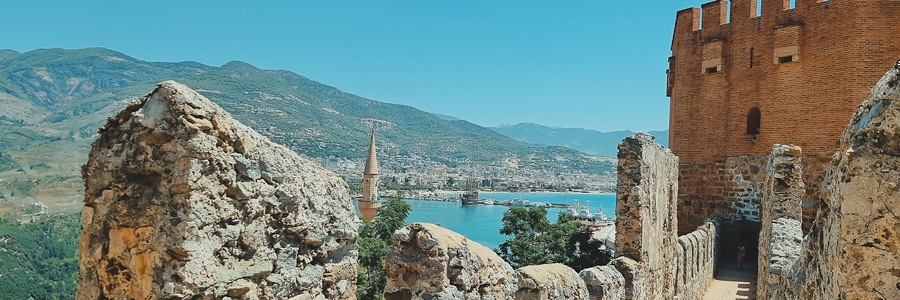 banner of view from old fortress wall of tower, city and sea, as well as minarets of the mosque. Alanya Turkey. soft focus.