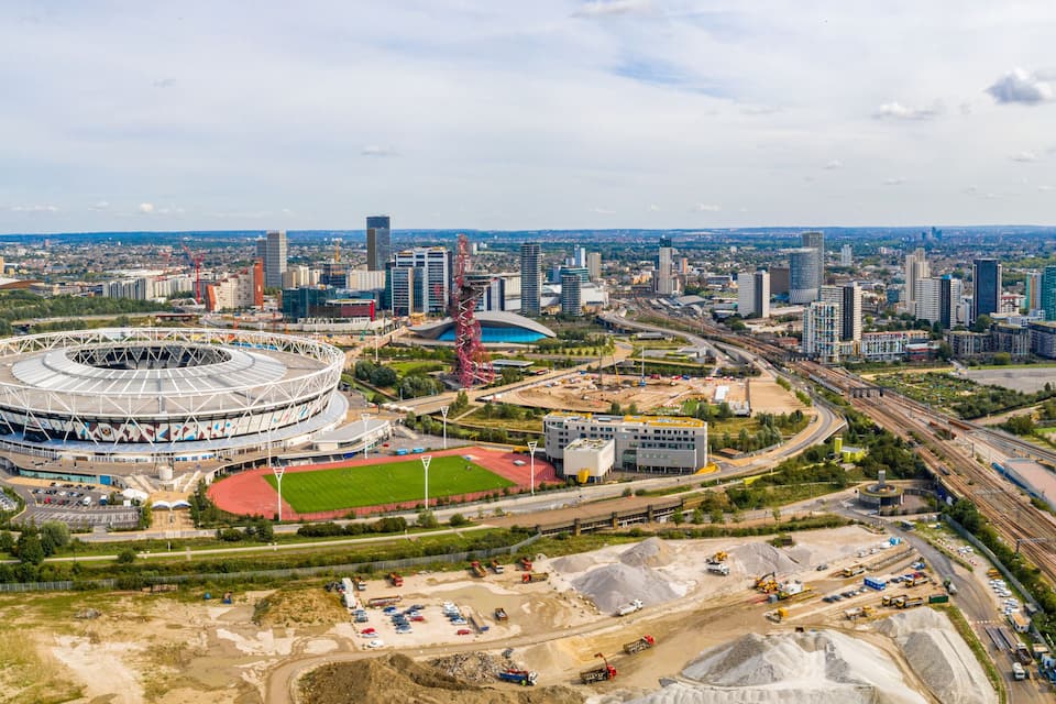 A stadium surrounded by modern buildings and highways.