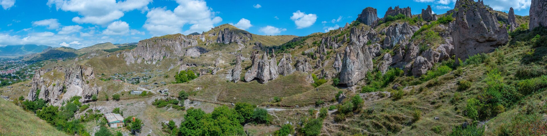 A mountainous landscape with rocky cliffs and sparse vegetation.