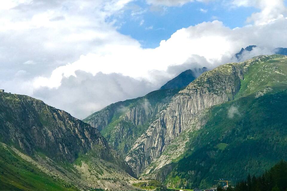 A mountainous landscape with steep cliffs and a valley.