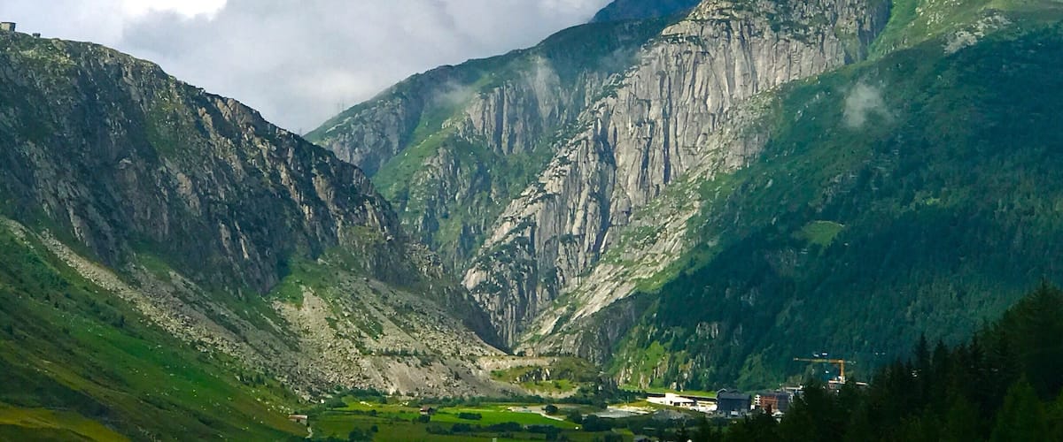 A mountainous landscape with steep cliffs and a valley.