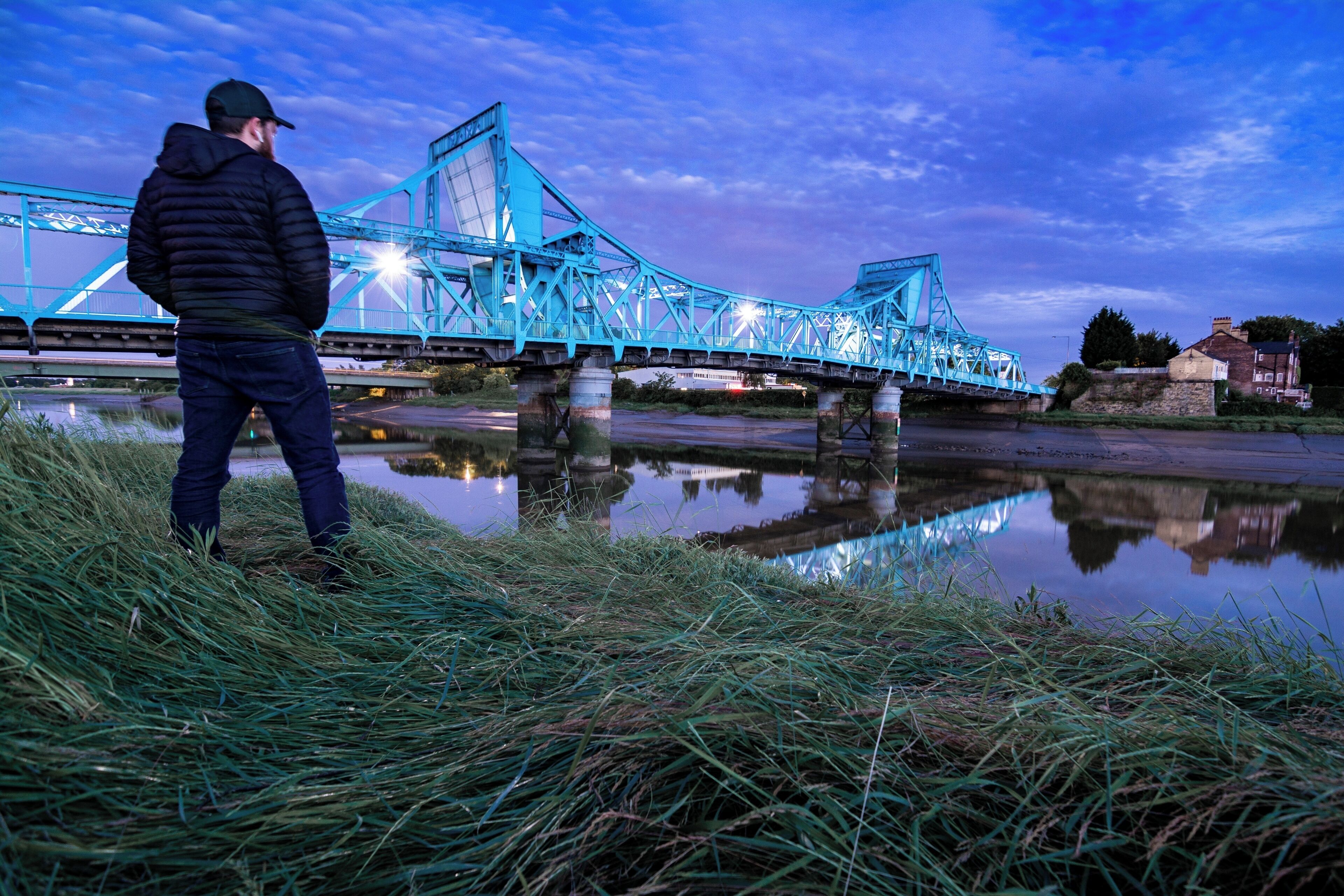 The Jubilee Bridge in Queensferry, Deeside, North Wales. We used to drive over the "Blue Bridge" a few times a week as a kid on our way to see my Nan. It has Grade 2 listed status, originally a double leaf rolling bridge but now a permanent road bridge over the River Dee.

Originally I wasn't happy with this photo - the wide-angle distortion, the fact my head's a tad out of focus - but considering the lack of compositional freedom at this spot I've come to appreciate it a little more.

Photo taken from the North bank along the North Wales cycle path. After this shot I decided to run onto the "beach" for a more travel-like selfie, but it's not sand... It's pure soft, sinking, stinking silt. I immediately decked it and covered myself in reeking silt and just about managed to get back up. Then only a few minutes later the tidal surge rushed through - counting myself very lucky!

VLOG coming soon!  This is why I always keep a spare change of clothes in the car...  

#deeside #jubileebridge #bluebridge #queensferry #northwales #northeastwales #riverdee #deeestuary #bvsblue #bluehour #reflections #rivercrossing #wideangle #clouds #d7100 #tokina1116 #luckytobealive #gottheshot