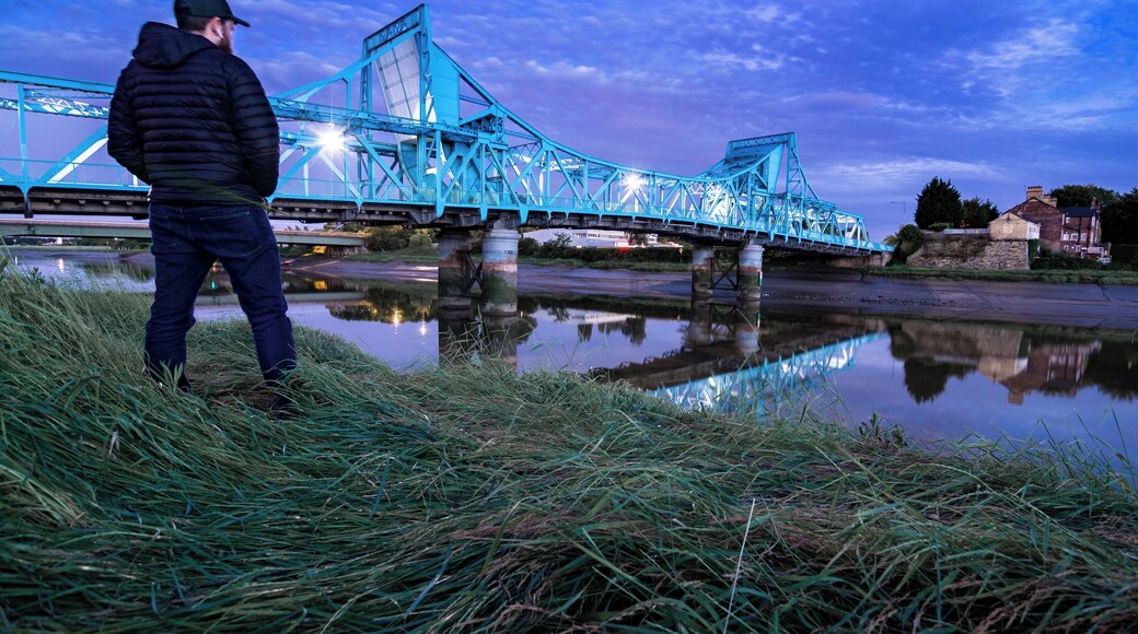 The Jubilee Bridge in Queensferry, Deeside, North Wales. We used to drive over the "Blue Bridge" a few times a week as a kid on our way to see my Nan. It has Grade 2 listed status, originally a double leaf rolling bridge but now a permanent road bridge over the River Dee.
Originally I wasn't happy with this photo - the wide-angle distortion, the fact my head's a tad out of focus - but considering the lack of compositional freedom at this spot I've come to appreciate it a little more.
Photo taken from the North bank along the North Wales cycle path. After this shot I decided to run onto the "beach" for a more travel-like selfie, but it's not sand... It's pure soft, sinking, stinking silt. I immediately decked it and covered myself in reeking silt and just about managed to get back up. Then only a few minutes later the tidal surge rushed through - counting myself very lucky!
VLOG coming soon! This is why I always keep a spare change of clothes in the car...
#deeside #jubileebridge #bluebridge #queensferry #northwales #northeastwales #riverdee #deeestuary #bvsblue #bluehour #reflections #rivercrossing #wideangle #clouds #d7100 #tokina1116 #luckytobealive #gottheshot