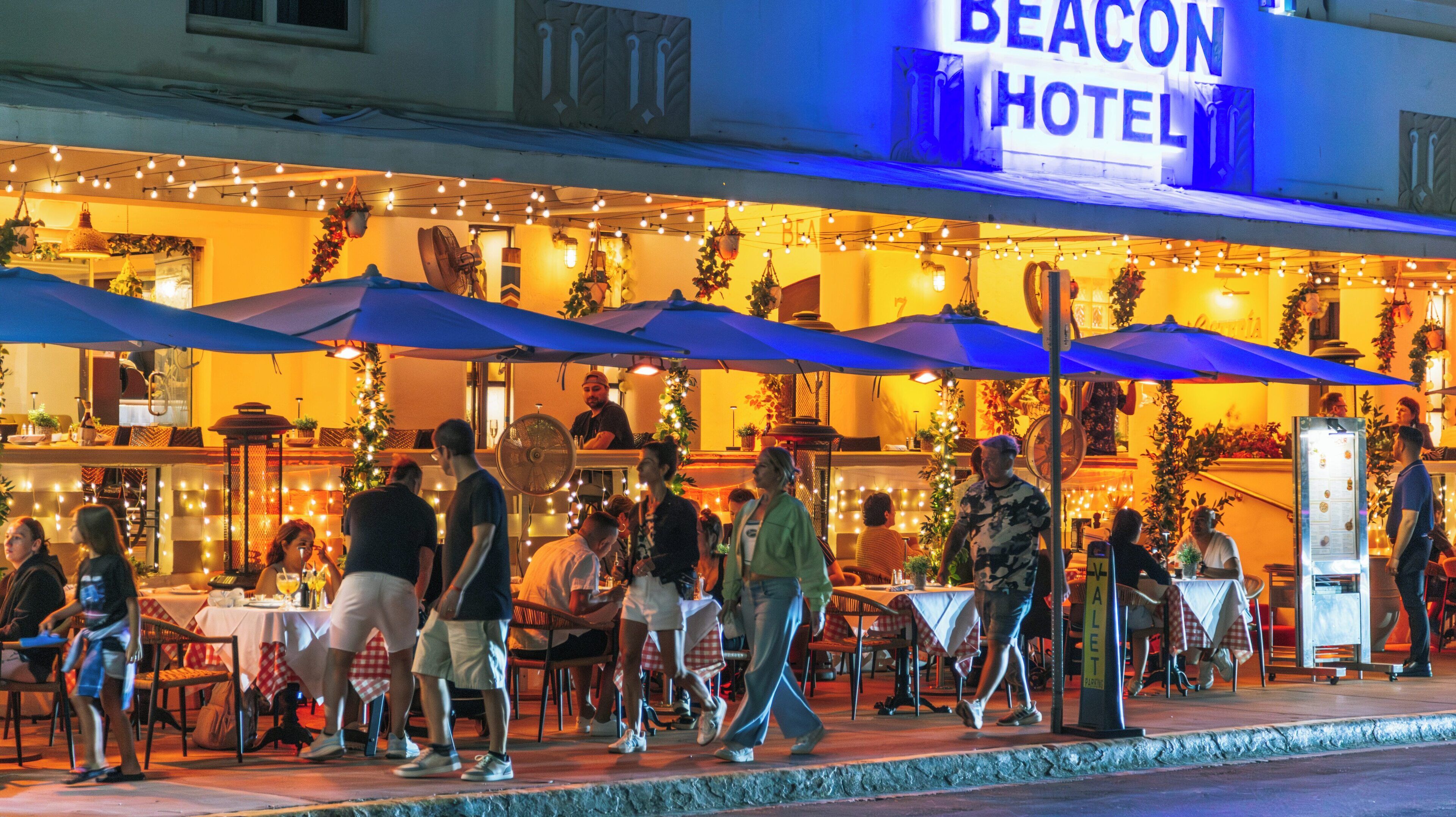 Vibrant evening on Ocean Drive in South Beach, Miami Beach, showcasing outdoor dining and lively atmosphere under twinkling lights