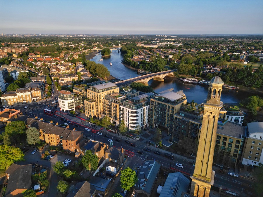 Aerial drone view of Kew Bridge over river Thames and a steam brick tower in Brentford, London, England, on a sunny summer day