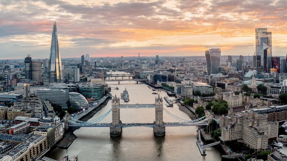 London aerial panoramic city view towards tower bridge, The Shard and River Thames. Aerial view at looking over tower bridge towards the city at sunset