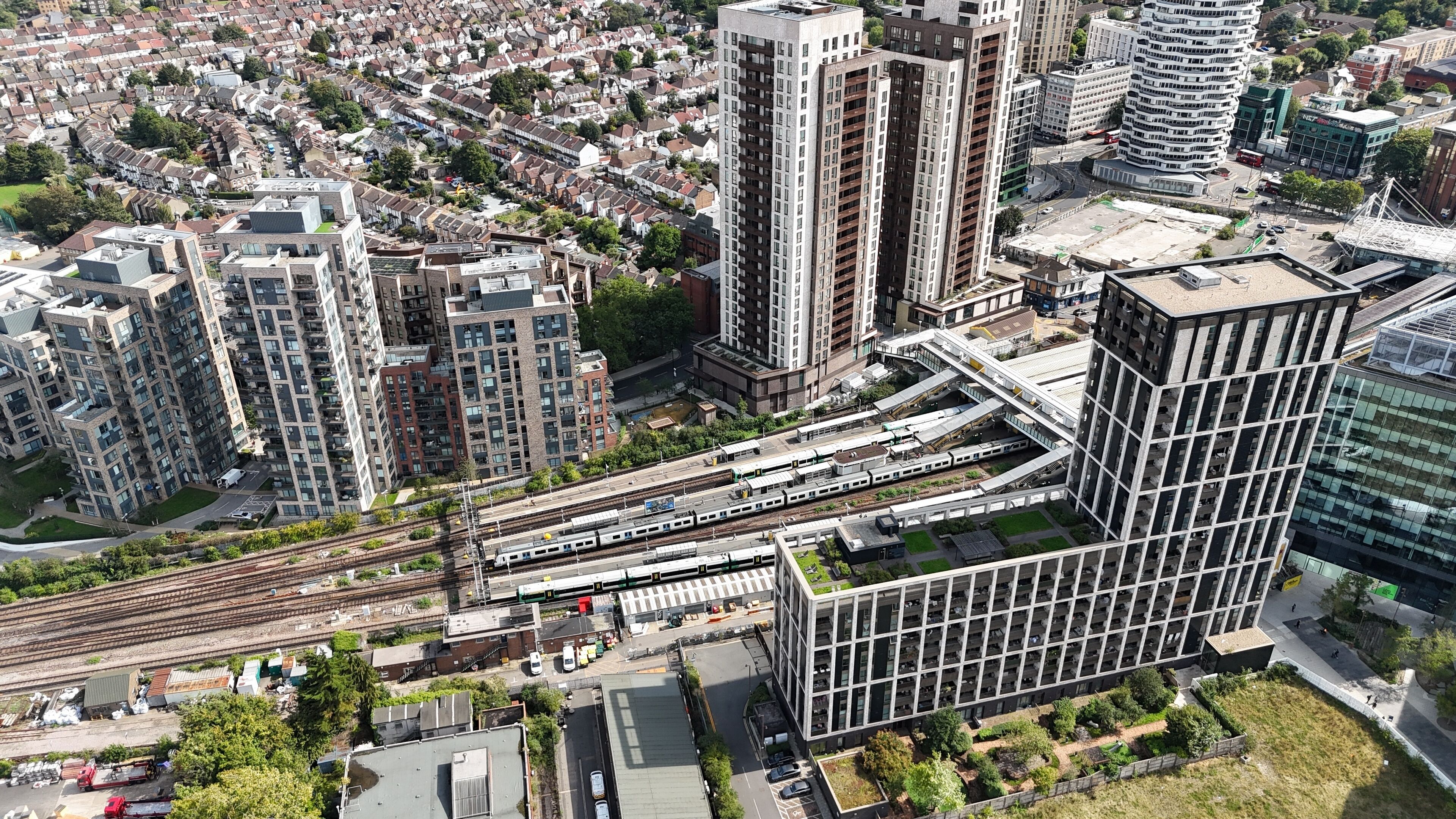 Train aproching station Croydon town centre south London UK drone,aerial