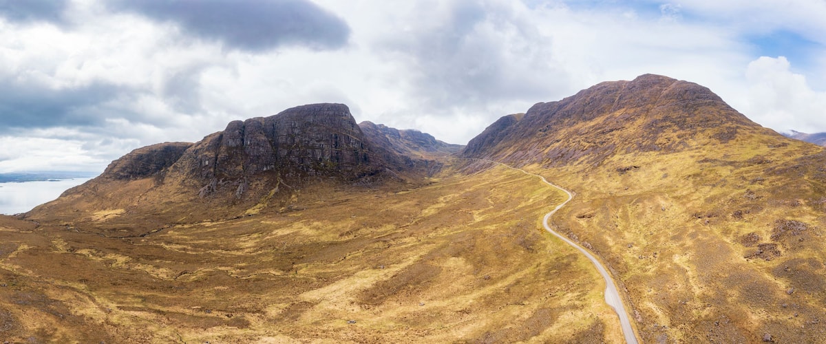 A mountainous landscape with a winding road.