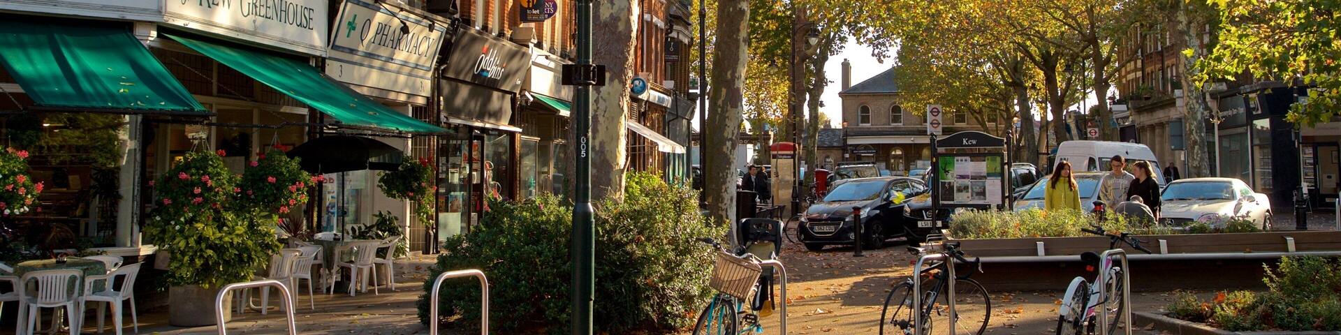 A street lined with brick buildings, a cafe, and a pharmacy.