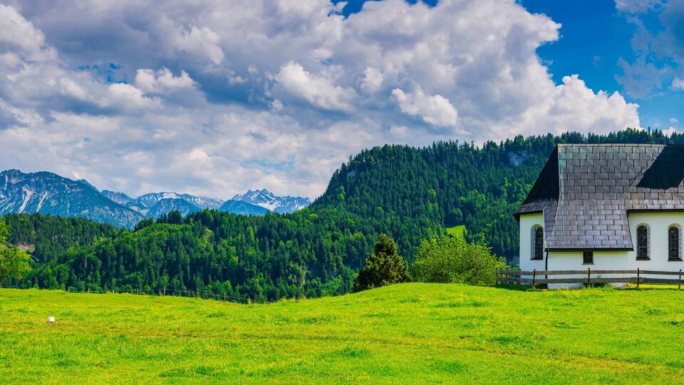 Germany, Bavaria, Obermaiselstein, Panorama of Kapelle Oberdorf with mountains in background
