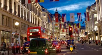 Vibrant evening at West End in London with flags and bustling traffic