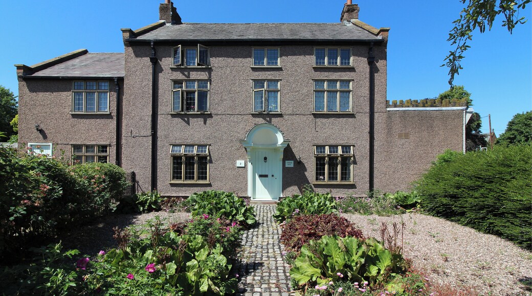 Grade II listed house on The Green, Willaston, early 19th century with later alterations. Roughcast on brick with slate roof.