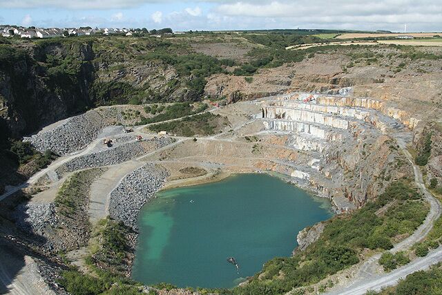 St Teath: Delabole Slate Quarry Seen from the viewing platform. The quarry has been worked since the fifteenth century and probably earlier. At one stage in the nineteenth century several steam engines were employed hauling slate up inclines: these have now gone and road transport is used to bring the slate to the surface
