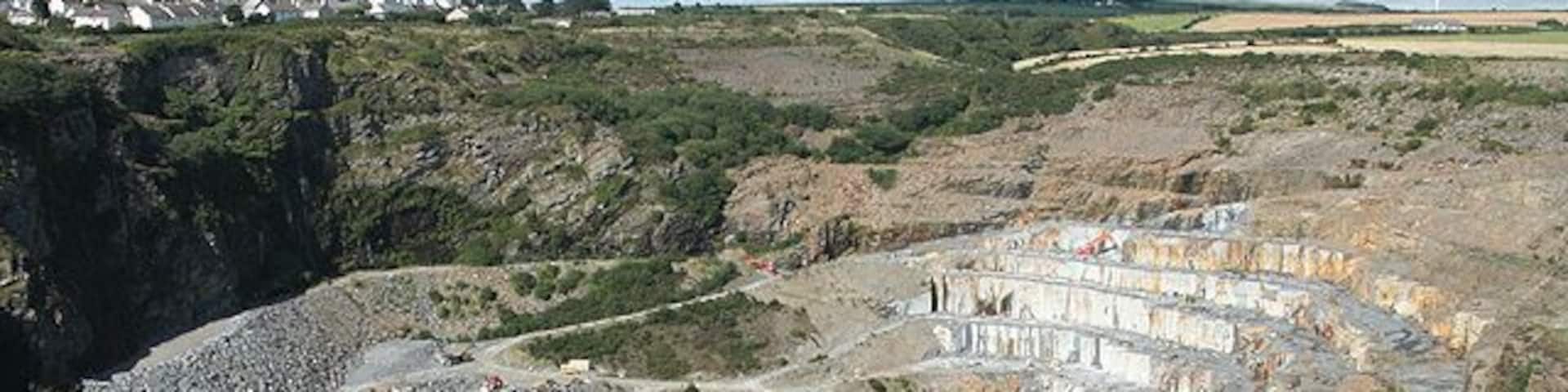 St Teath: Delabole Slate Quarry Seen from the viewing platform. The quarry has been worked since the fifteenth century and probably earlier. At one stage in the nineteenth century several steam engines were employed hauling slate up inclines: these have now gone and road transport is used to bring the slate to the surface