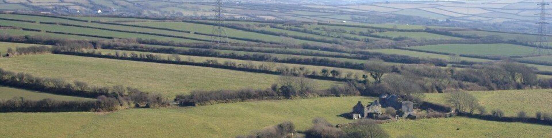 The View from Delabole Waste Tip The quarry waste tip does not rise above the level of the land at Delabole but as it juts out into valley below there is a very steep drop onto farmland to the southeast.