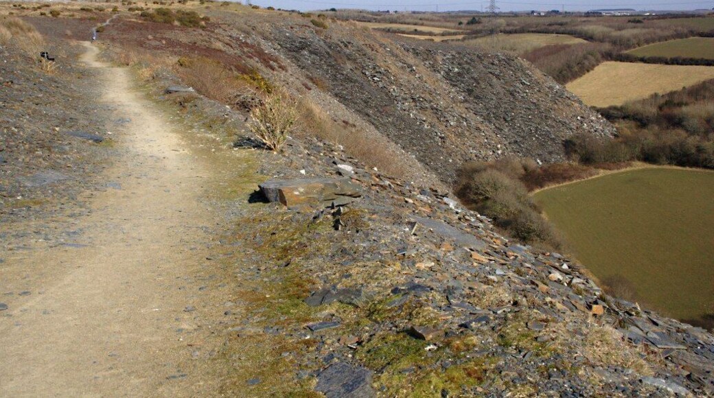 On the Spoil Heap at Delabole The scale and height of the waste from the pit at Delabole is perhaps as impressive as the pit itself. There is an easy footpath around the top of the waste tip.