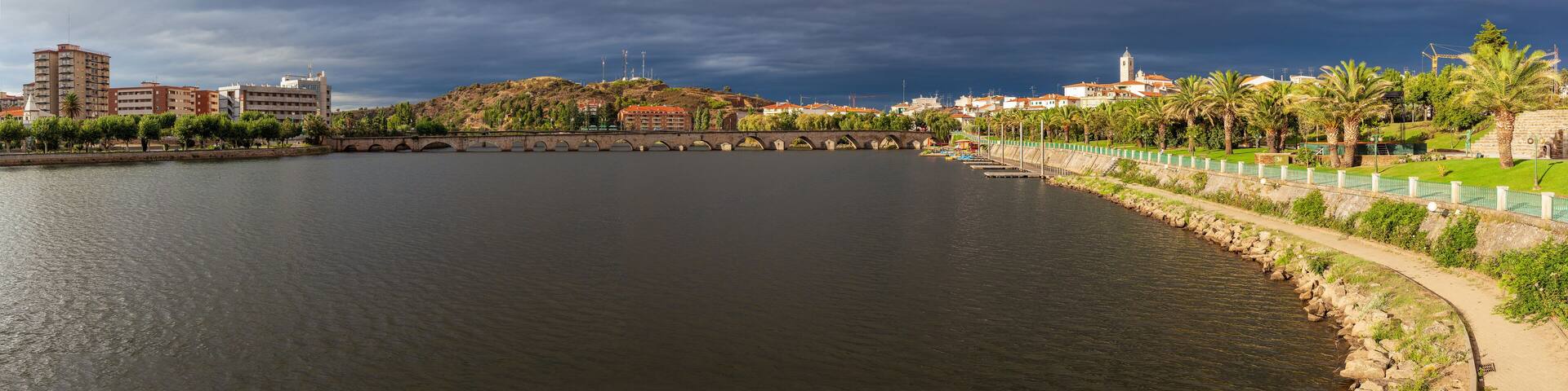Urban landscape of the city of Mirandela in the north of Portugal. Panoramic view of the banks of the river Tua with the traditional Roman bridge and the historic center with its church tower.