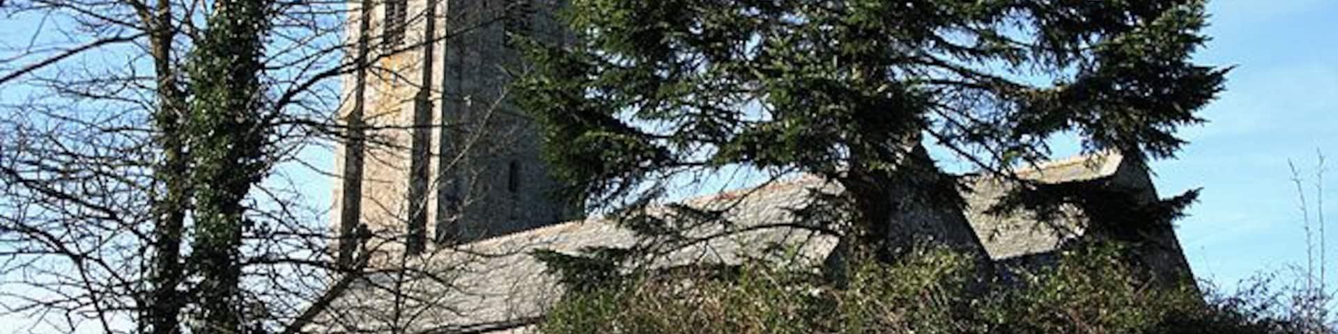 Broadwoodkelly: All Saints Church The church, dedicated to All Saints, has a tower with set-back buttresses. The medieval dedication has been lost. Looking north west