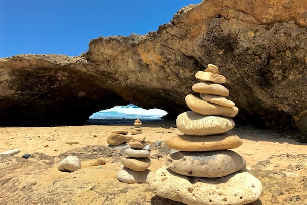 After visiting the Aruba Bushirbana Ruins (Old Sugar Mill), Lynn and I drove North along a dirt road that followed the East coast ocean cliffs for about 1 mile and came across this isolated private beach. There was no-one out here as everyone turns around at the Ruins. I donât have a name for this beach, but Google Maps identifies as Wariruri Bay and the map tag is exactly where the pic was taken. One of the intriguing things about this area on the East Coast of the island is that there are 100s of Thousands of rock stacks. They carpet the coast and were even found in this isolated beach. If visiting the island, rent your own car or jeep to explore the vast dirt roads that follow the coast line at your leisure. Most tours will turn around at the Ruins. #BeachTips
#LocalSecrets
#Trovember