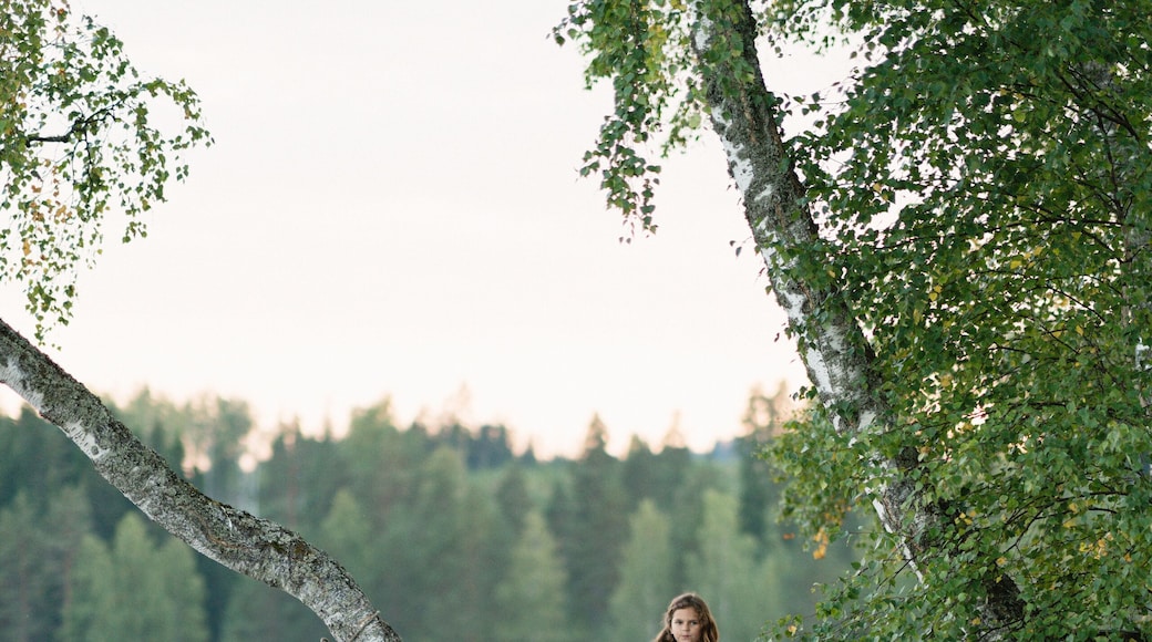 Sweden, Vastmanland, Hallefors, Bergslagen, Girl ( 8-9) standing on lakeshore