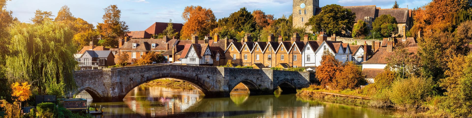 Panoramic view of Aylesford village in Kent, England with medieval bridge over the river Medway during golden autumn time