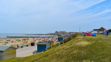 Tourists on their summer holidays, Minnis Bay, Birchington, Kent, UK