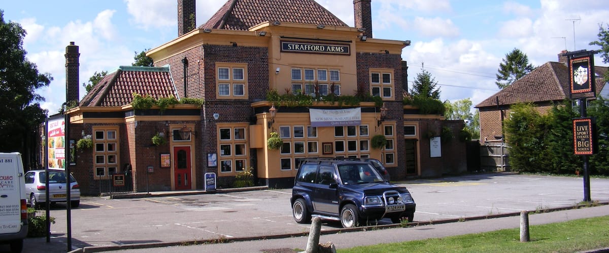 A building with a sign reading "Strafford Arms."