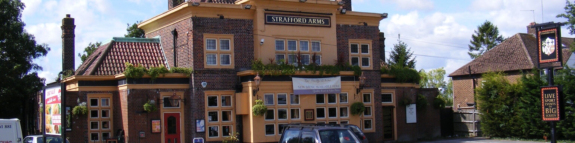 A building with a sign reading "Strafford Arms."