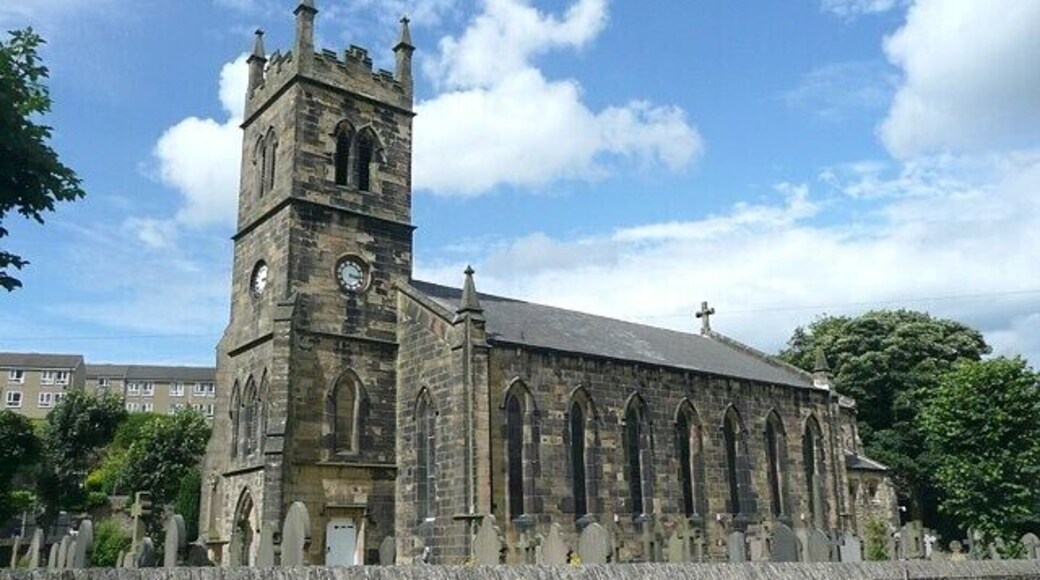 St David's Church, Holmbridge This view from the car park shows the seven tall lancet windows at the south side of the nave. Pevsner records that the chancel was added in 1887.