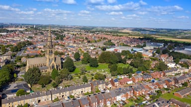 A town with a prominent church tower, residential areas, and surrounding fields.