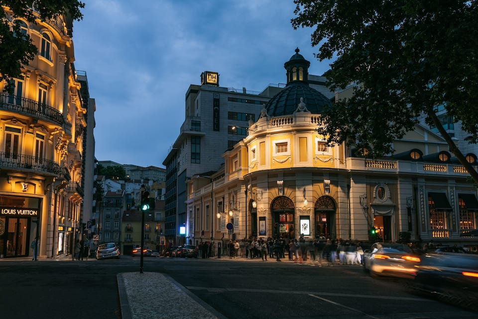 A historic building with a dome and a Louis Vuitton store.